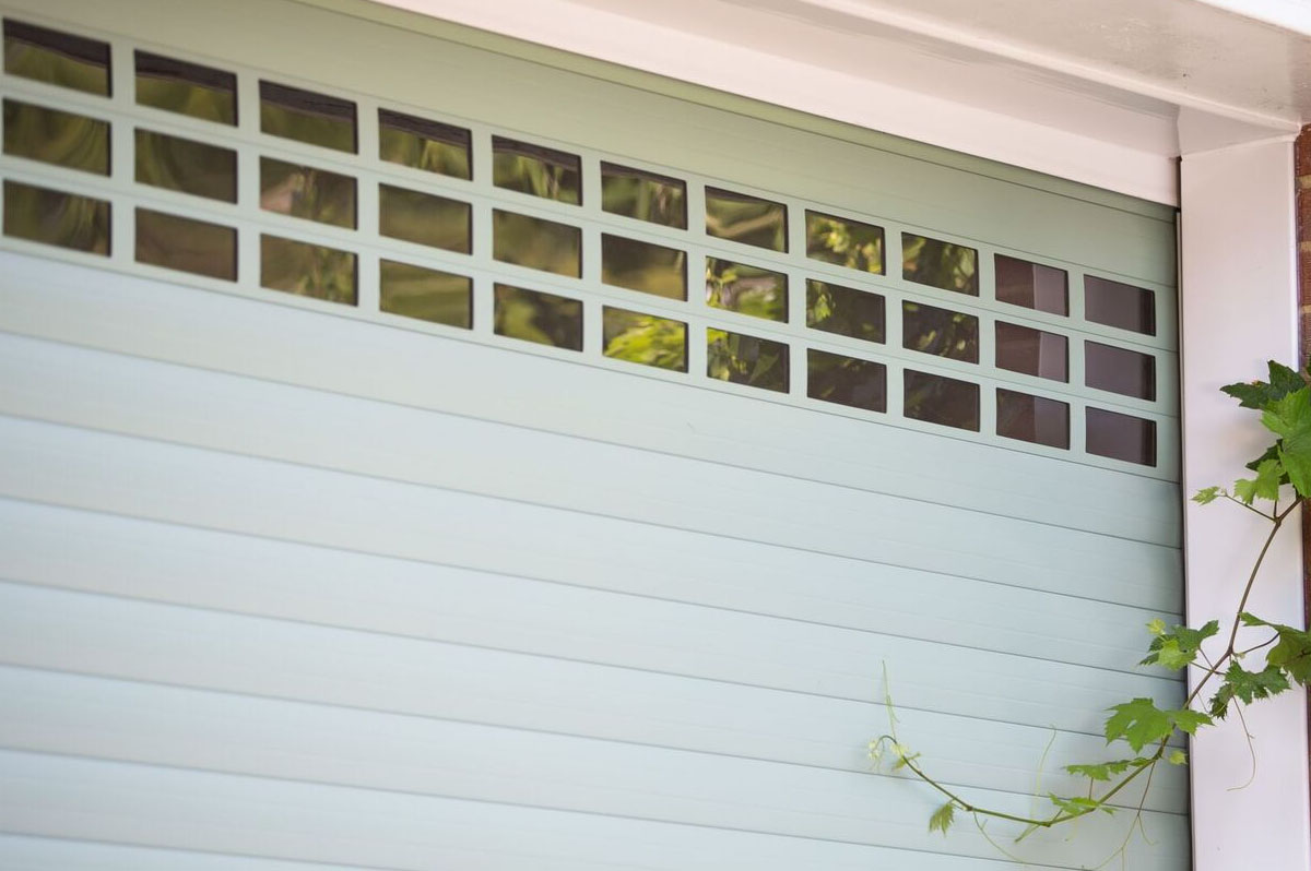 Close up of Green roller doors with Vision Slats at top